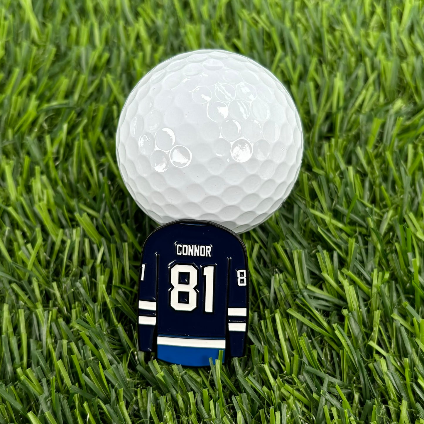 Kyle Connor golf ball marker with jersey number 81 on grass, high-quality and durable personalized golf accessory