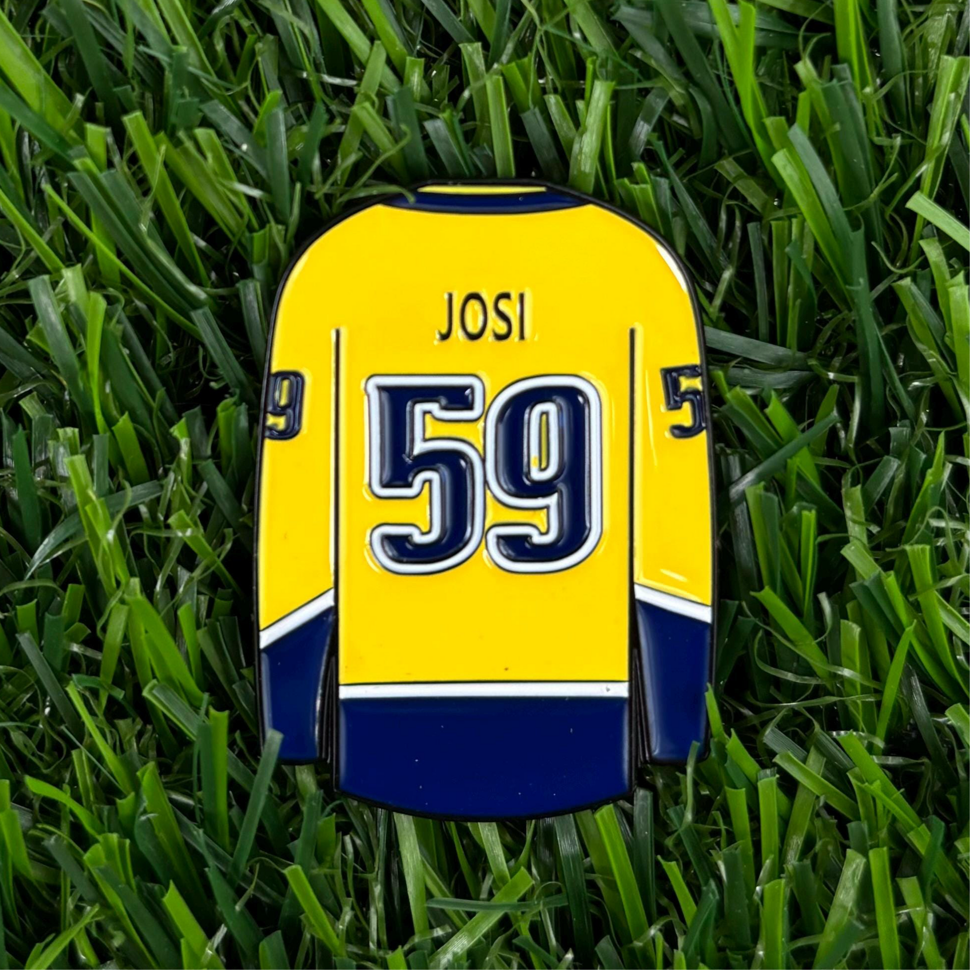 High-quality Roman Josi custom golf ball marker in grass, premium and durable golfing accessory.