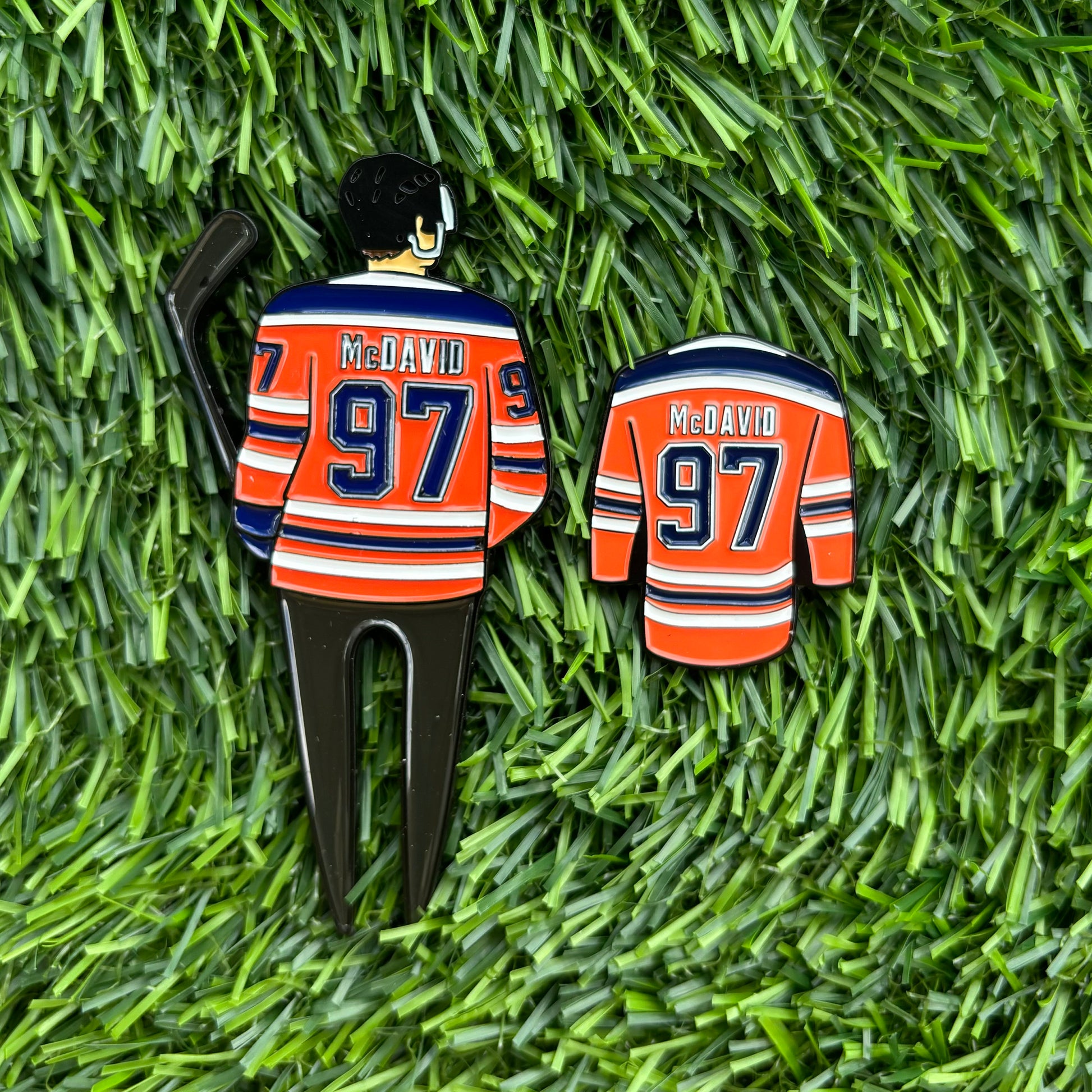 McDavid golf divot tool and ball marker set on grass, perfect gift for golf enthusiasts, includes unique ball marker and golfing accessory