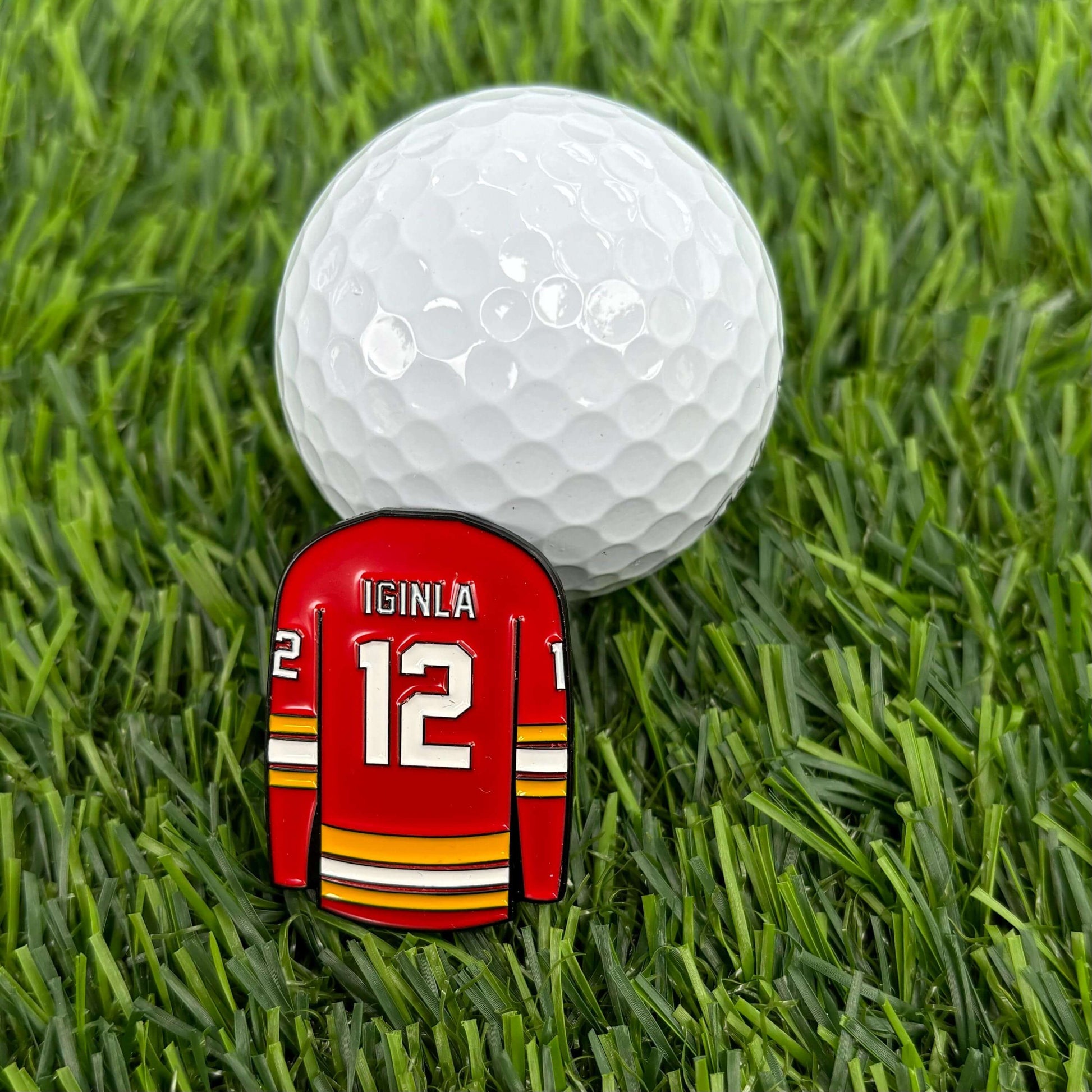 Jarome Iginla custom golf ball marker with a golf ball on green grass