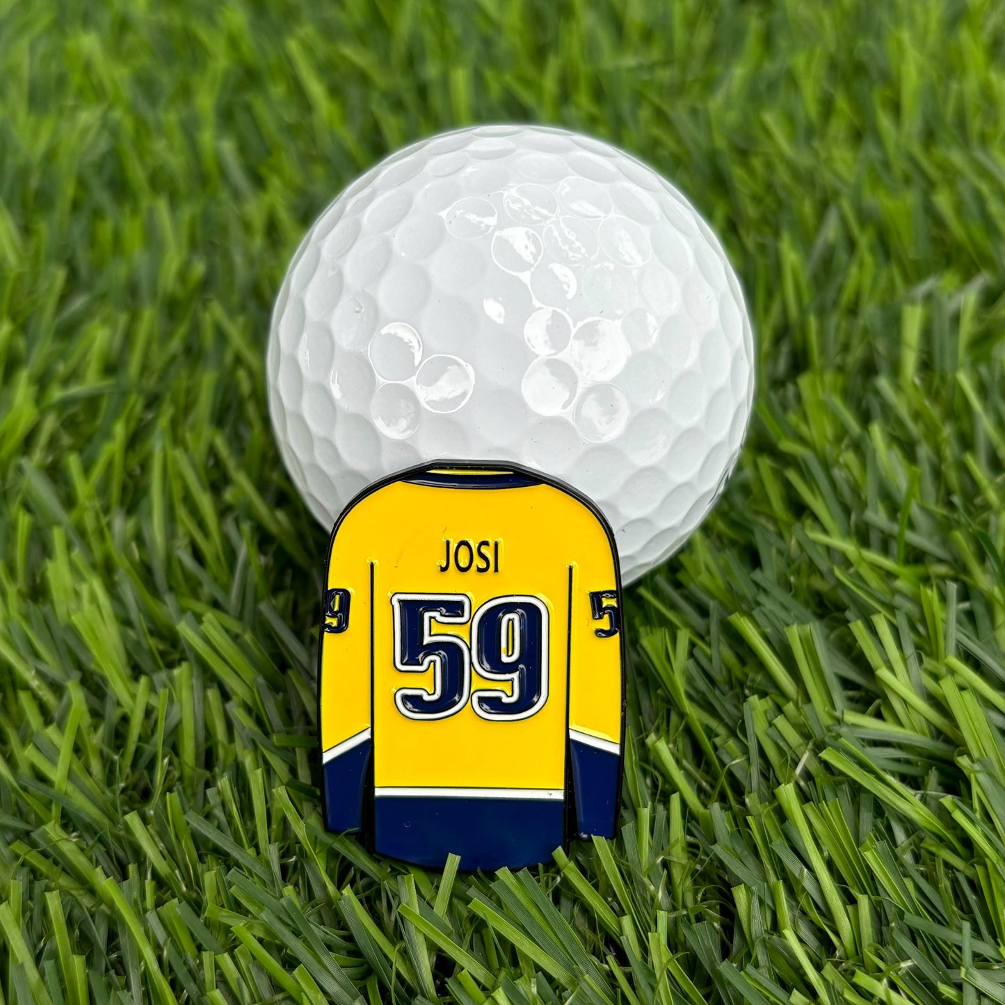 Roman Josi custom golf ball marker with jersey design on grass, premium and durable golf accessory for golfers