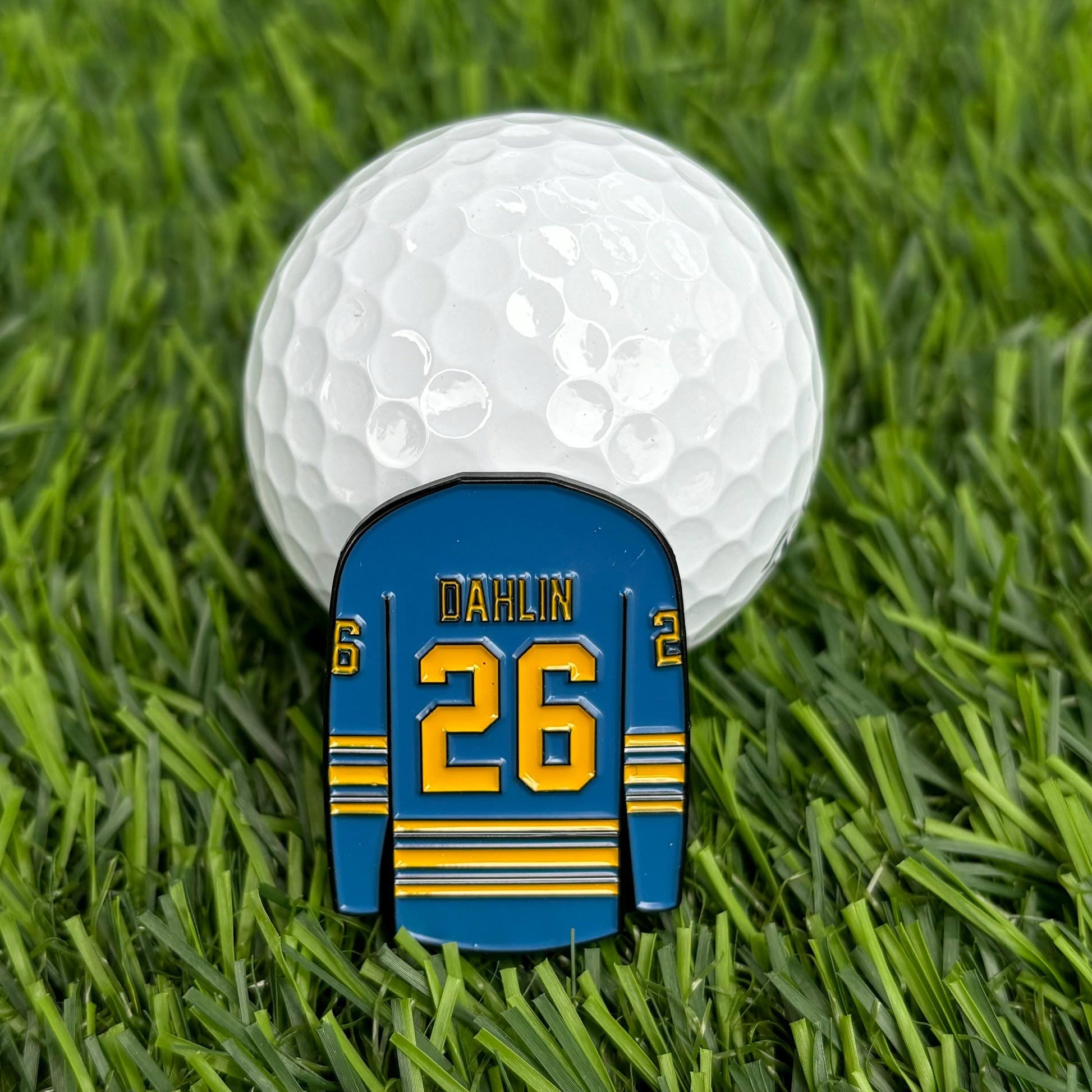 Rasmus Dahlin personalized golf ball marker with jersey design #26 on grass next to golf ball