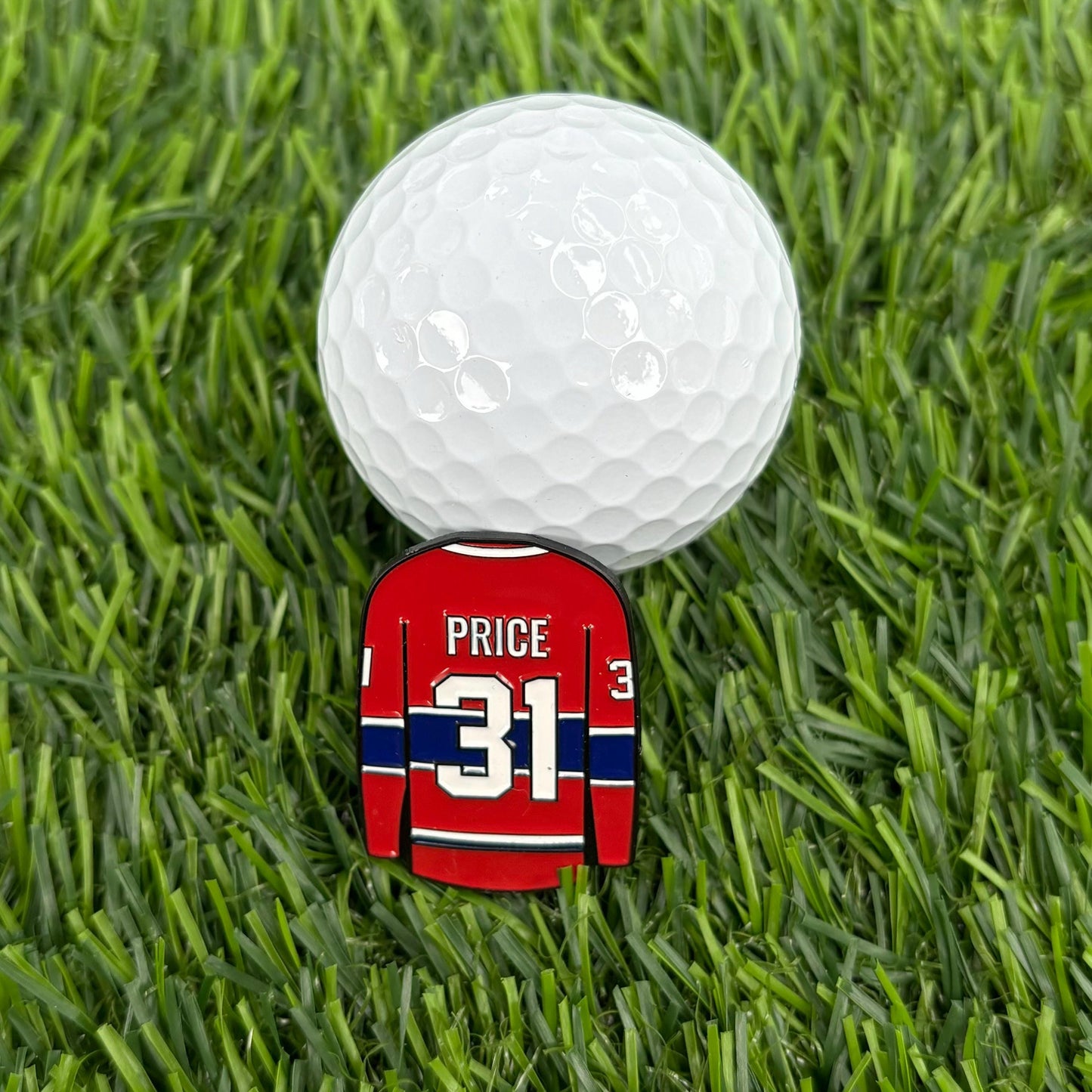 Carey Price golf ball marker on grass with golf ball, durable and personalized for golfers, high-quality sports collectible accessory