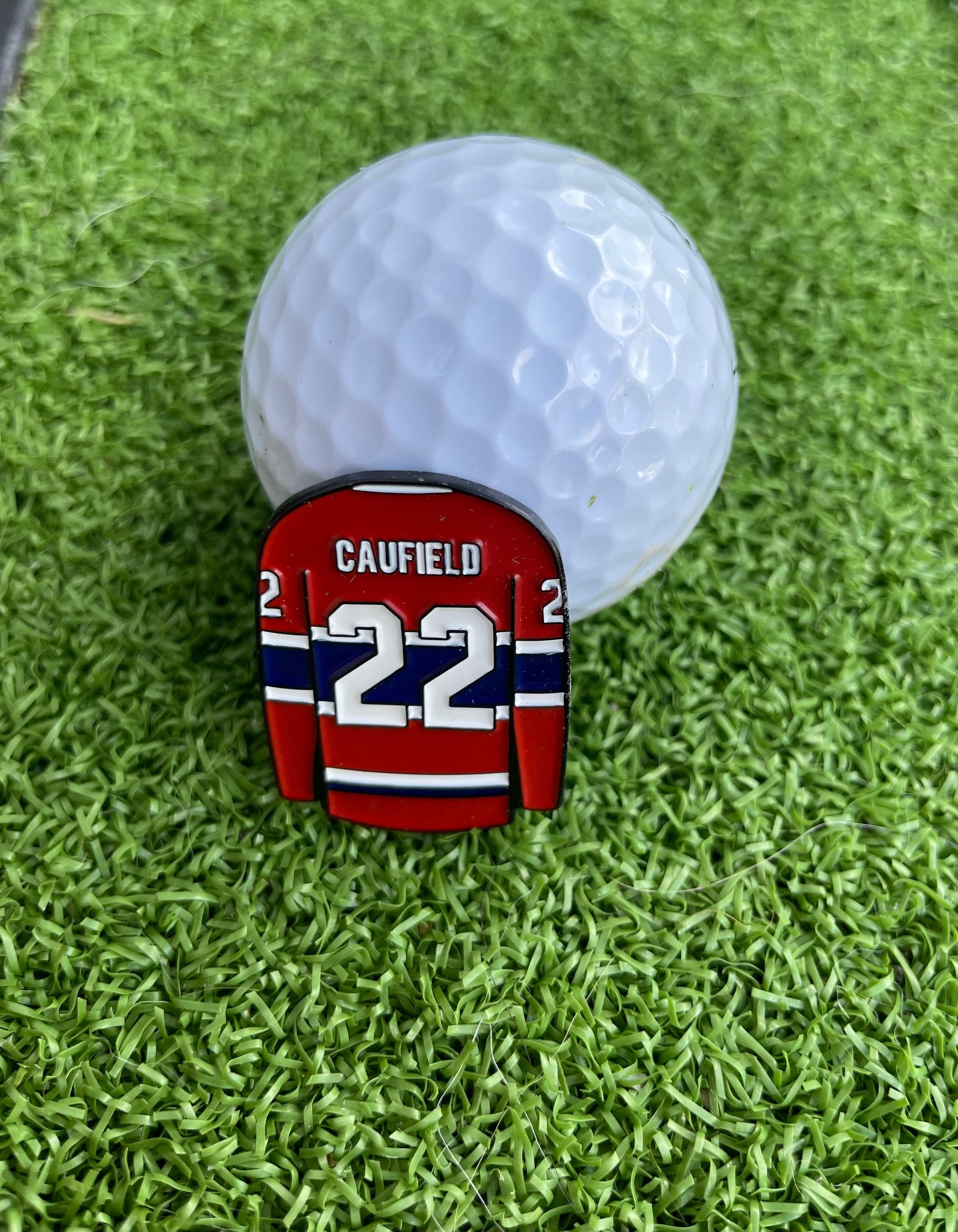 Sandybirds Golf Gear Caufield Ball Marker - Premium quality golf ball marker made of zinc alloy, designed in the shape of a Caufield jersey. A perfect accessory for golf enthusiasts looking to add a touch of style and precision to their game.